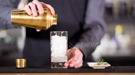 an experimental cocktail waiter makes a special drink in a bar lounge in spain