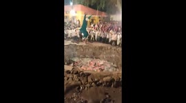Indian devotee jumps into fire pit and tosses hot embers in air with bare hands