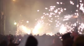 crowds in the street for the fire run or correfoc, during la merce festival, barcelona spain
