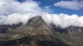 Clouds roll of the edge of Table Mountain in Cape Town