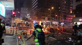 Hong Kong, A fire burns as multiple rounds of tear gas are fired