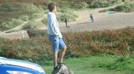 Gay couple looking at Surfer and in turn Surfer looks  at newly married couple having wedding photos taken