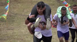 Colombia's first wife-carrying championship sees contestants navigate 700m course
