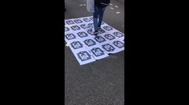 Hong Kong protesters walk over images of Xi Jinping images on China National Day