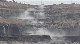 Dramatic moment river changes course and plunges into huge coal mine in India