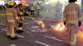 Fire Services extinguish a fire on a main road in Wanchai during protests on China's National Day