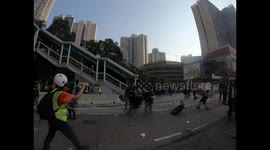 Hong Kong police draw guns on protestors hurling objects during heated clash on China's National Day