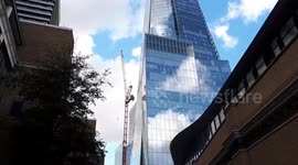 Police cordon off the Shard as man scales nearby crane and 'threatens to harm himself'
