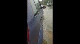 Heroic UK man rescues stranded women by pushing flooded car with one hand while recording