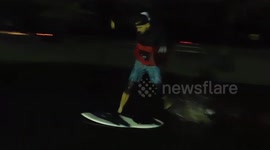 Flooding in Canada Man goes Skim boarding in field