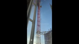 Man scales crane next to Shard