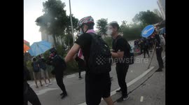 Protesters throw bricks and molotov cocktails to push back riot police which responds with tear gas in Wong Tai Sin
