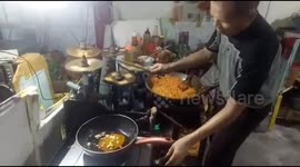 food vendors in the city of padang cook fried rice accompanied by music and play drums