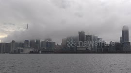 Ominous dark clouds of crisis over Toronto business and financial district after thunderstorms bring heavy rain to the city