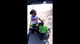 Toddler riding through the neighborhood