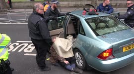 Police remove Extinction Rebellion protesters chained to car outside Ministry of Defence in London