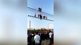 Chinese attraction workers rescue tourists dangling from pedestrian suspension bridge