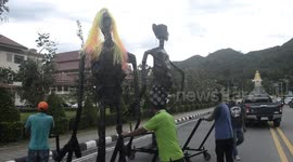 Bizarre ghoul-like sculptures transported on Thai road for festival