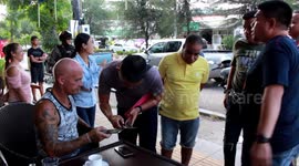 Motorcyclist snatches tourist's bag when he drinks coffee in Thailand