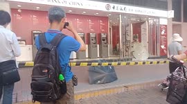 Hundreds of bank notes scattered across the ground after ATMs are attacked in Hong Kong
