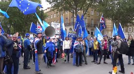 Police line up Whitehall as a group of protesters demands to Stop Brexit opposite Number 10 during Extinction Rebellion shutdown of Westminster