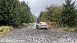 Cars drift around corners in Wales during World Rally Championship