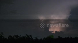 Several aircraft fly towards lightning storm above Pathum Thani, Thailand