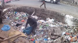 Nairobi slum-dweller sifts through knee-deep waste to collect plastic for recycling