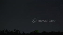 An airplane flies into a raging lightning storm over Pathumthani, Thailand.(closeup version #2).