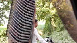 Indian man rides with 17 chairs strapped to his motorcycle in northern India.