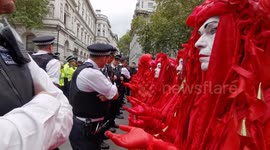 Red Brigade Protesters stand in front of police in London