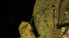 the famous cliff divers in acapulco, mexico at night