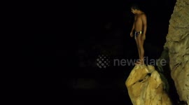 the famous cliff divers in acapulco, mexico at night