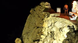 the famous cliff divers in acapulco, mexico at night