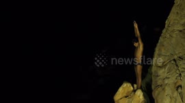 the famous cliff divers in acapulco, mexico at night