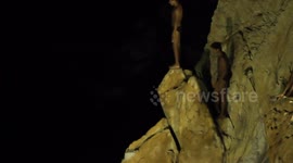 the famous cliff divers in acapulco, mexico at night