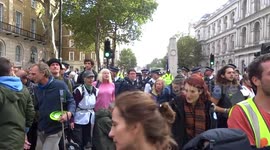 Keep moving! Police keep pressure on Extinction Rebellion activists to leave their camp opposite No 10 in Whitehall