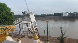 Landslide sparks panic as river bank and buildings collapse into water in Thailand