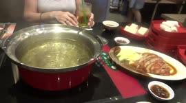 Tom yum soup cooking in MK Restaurant, Thailand.