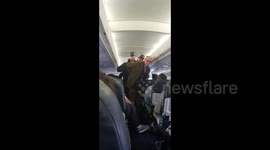 Moment Extinction Rebellion protester is arrested on board plane after stopping flight from London City Airport