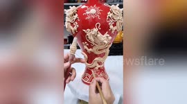 Chinese man shows off incredible handicraft skills while decorating vases