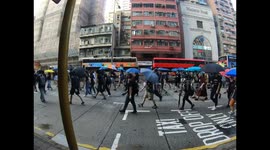 Protesters march to the sound of Glory to Hong Kong in Sham Shui Po