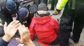 Climate change protester glues his hand to the road outside City Airport.