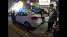 Protesters deflate tyres of a car found later to belong to Hong Kong scientific police