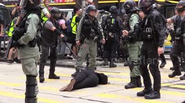 Hong Kong police drag woman across street after pepper-spraying her at point-blank range