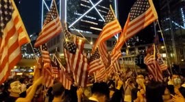 Hong Kong Protesters singing the USA national anthem while waving the stars and stripes in Central, Hong Kong