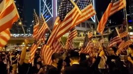 Thousands of pro-democracy protesters throng Hong Kong's Chater Garden waving US flags