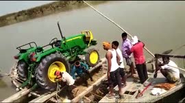 Two-ton tractor rowed across Indian river on rickety raft