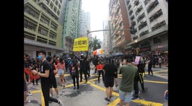 Protesters signal their comrades via banners similar to those used by the police
