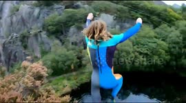 Watch moment daredevil somersaults 73ft into lake at bottom of huge quarry in Wales